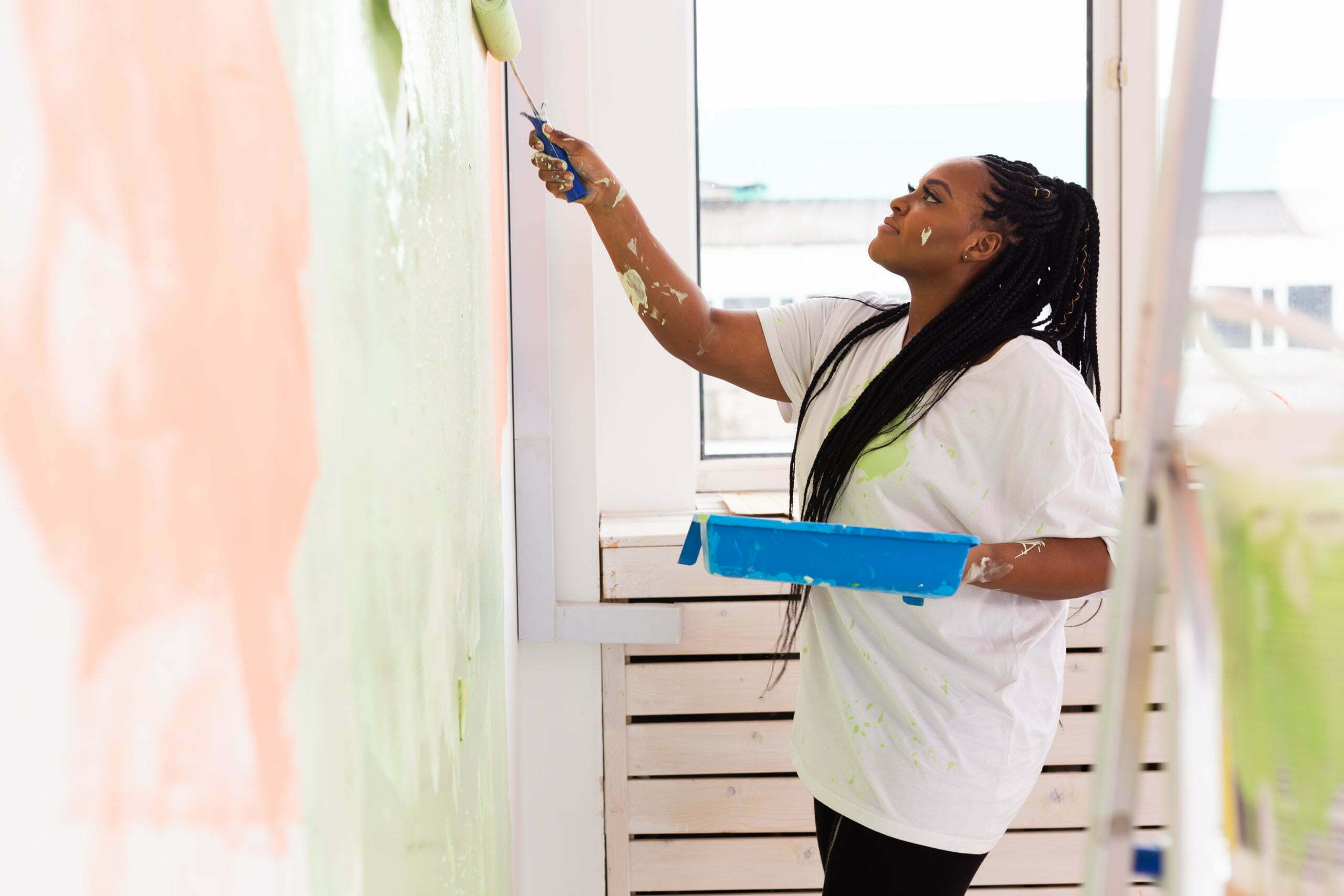 Woman painting walls during home renovation and lifestyle updates