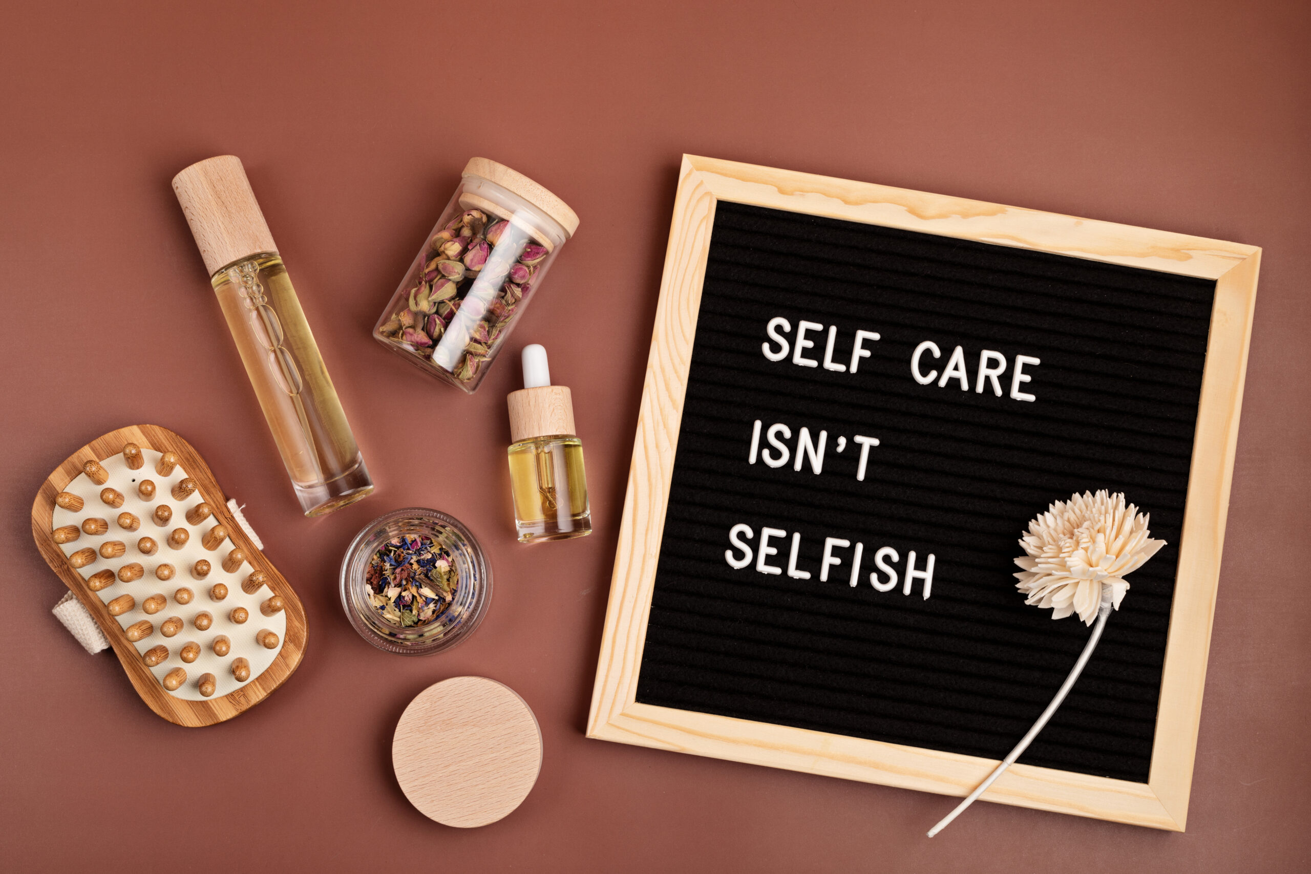 Letter board displaying "Self care isn't selfish" with wellness items and self-care essentials