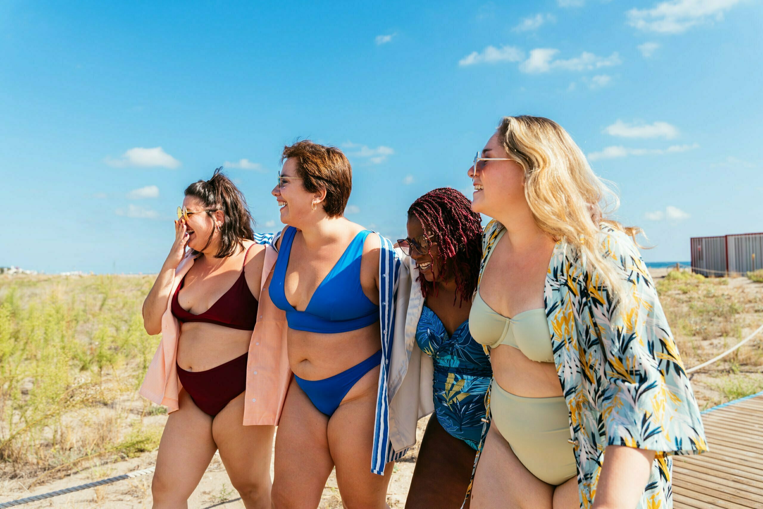Plus size women in swimwear at the beach, swimwear body type guide