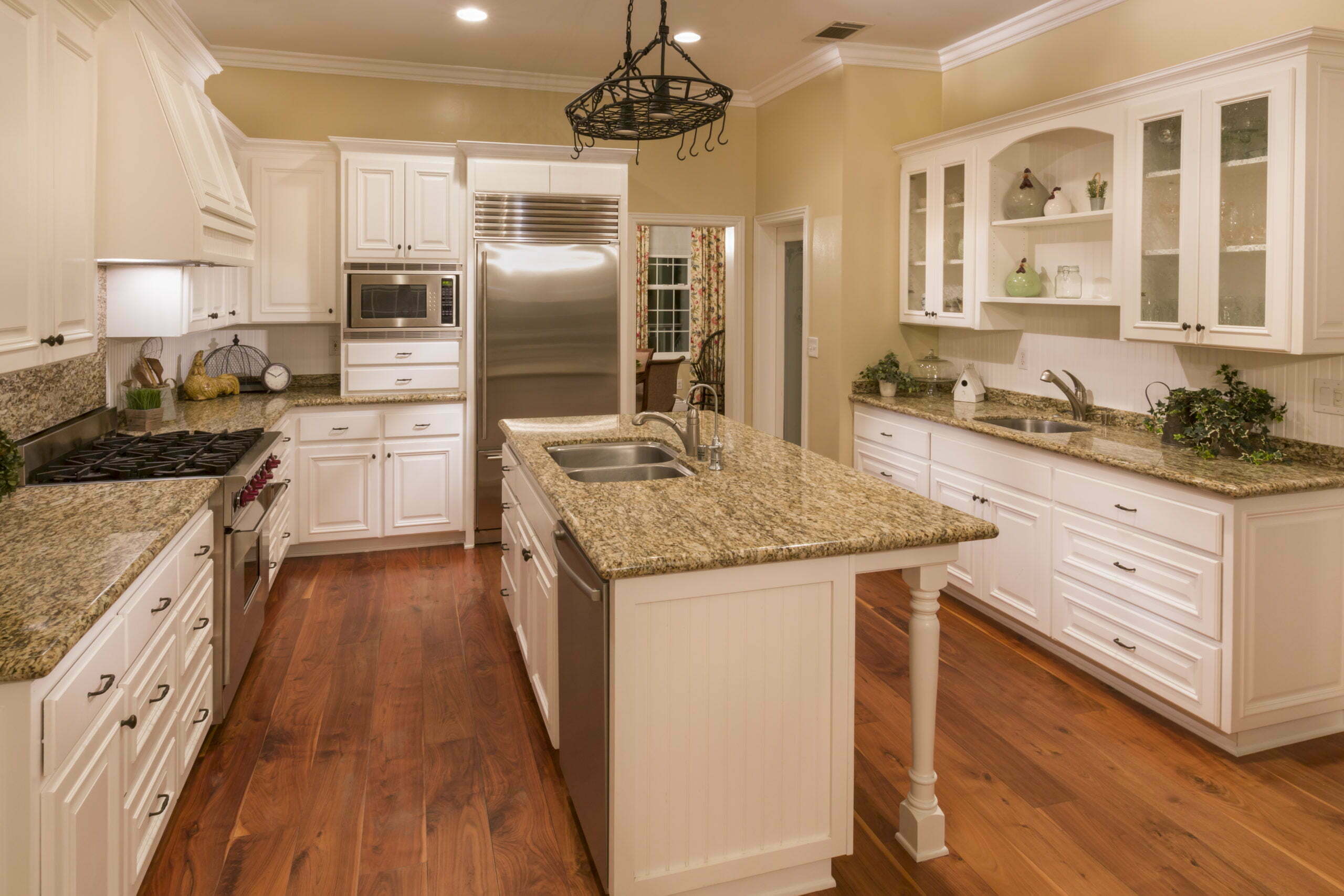 Custom kitchen interior with white cabinetry and granite countertops, remodeling ideas for home customization.