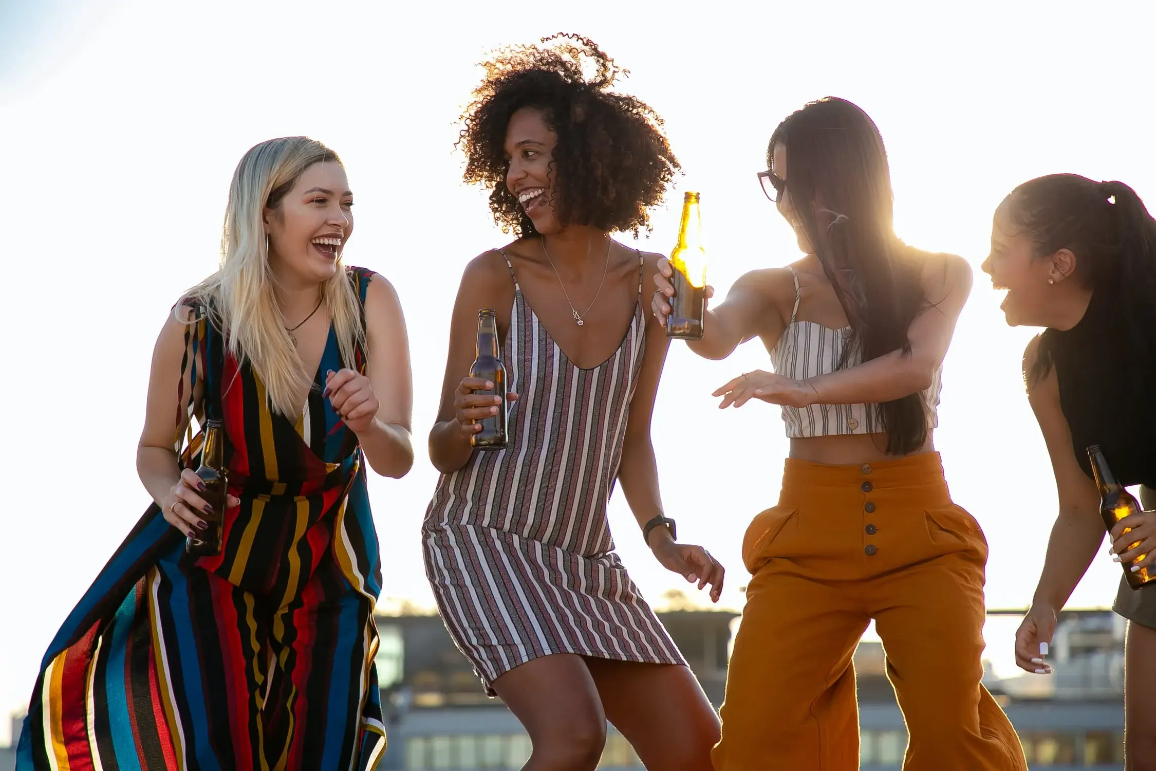 Friends celebrating with drinks in a backyard party setting.
