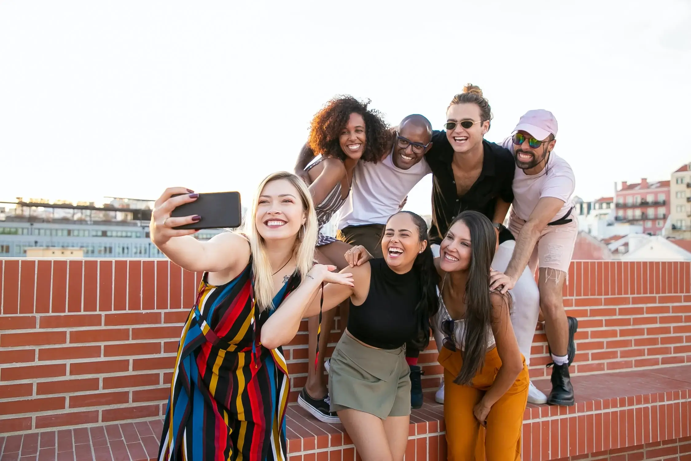 Group of friends taking selfie on rooftop, lifestyle and wellness themes