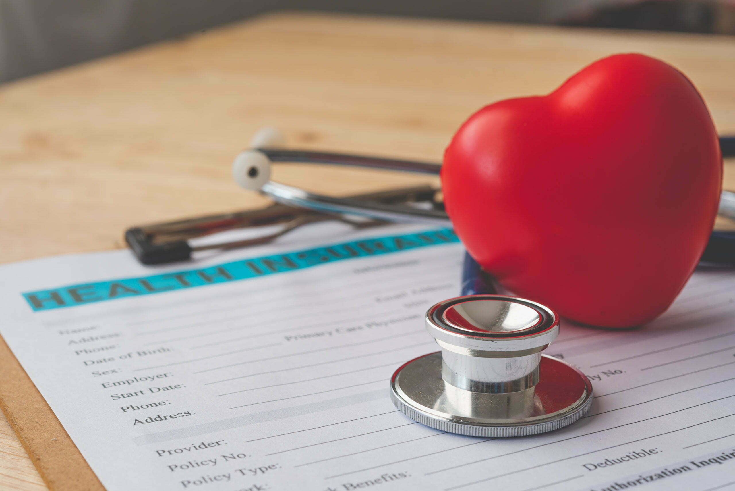 Stethoscope and health insurance paperwork representing wellness and healthcare benefits.