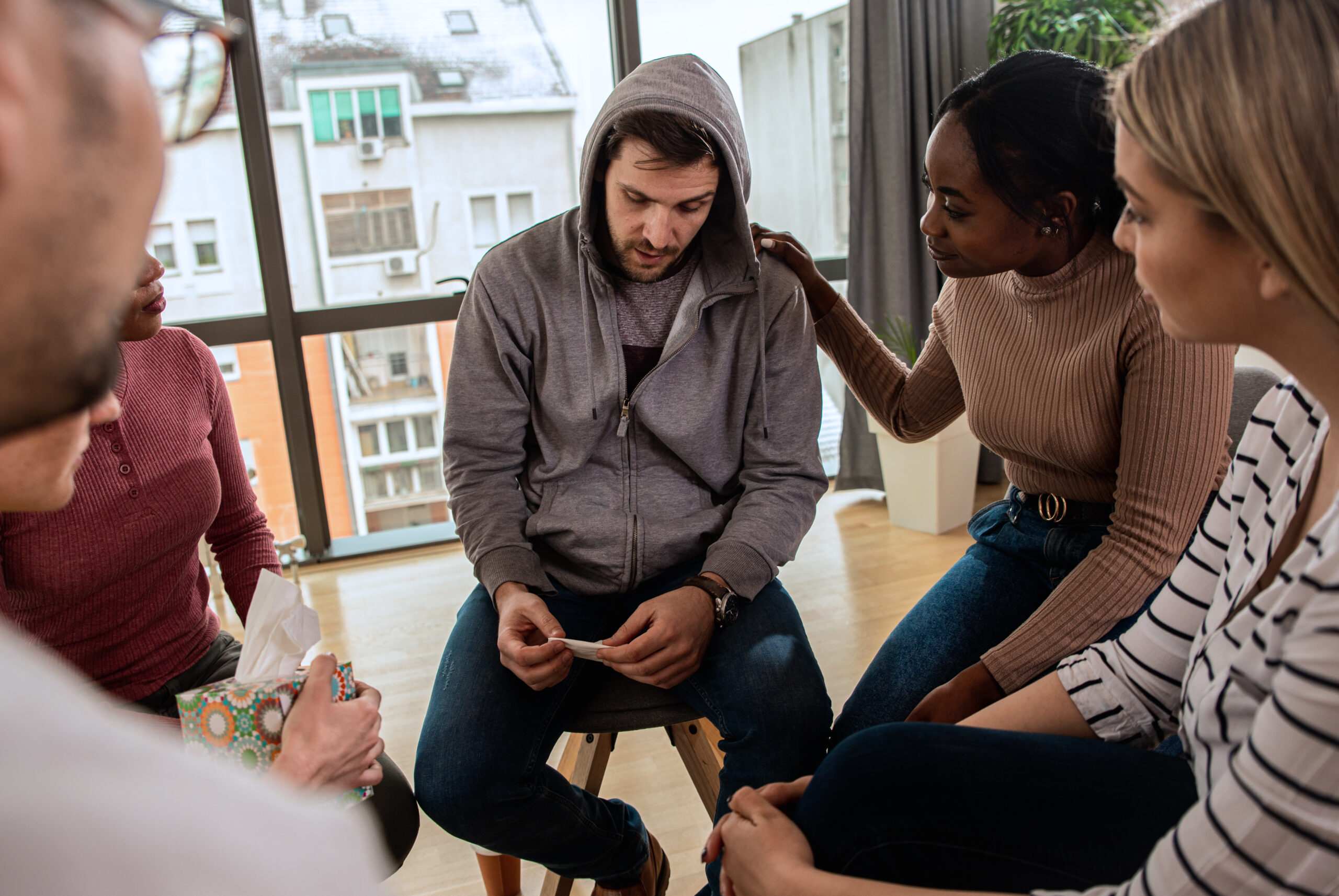 Support group meeting addressing addiction recovery and seeking help.